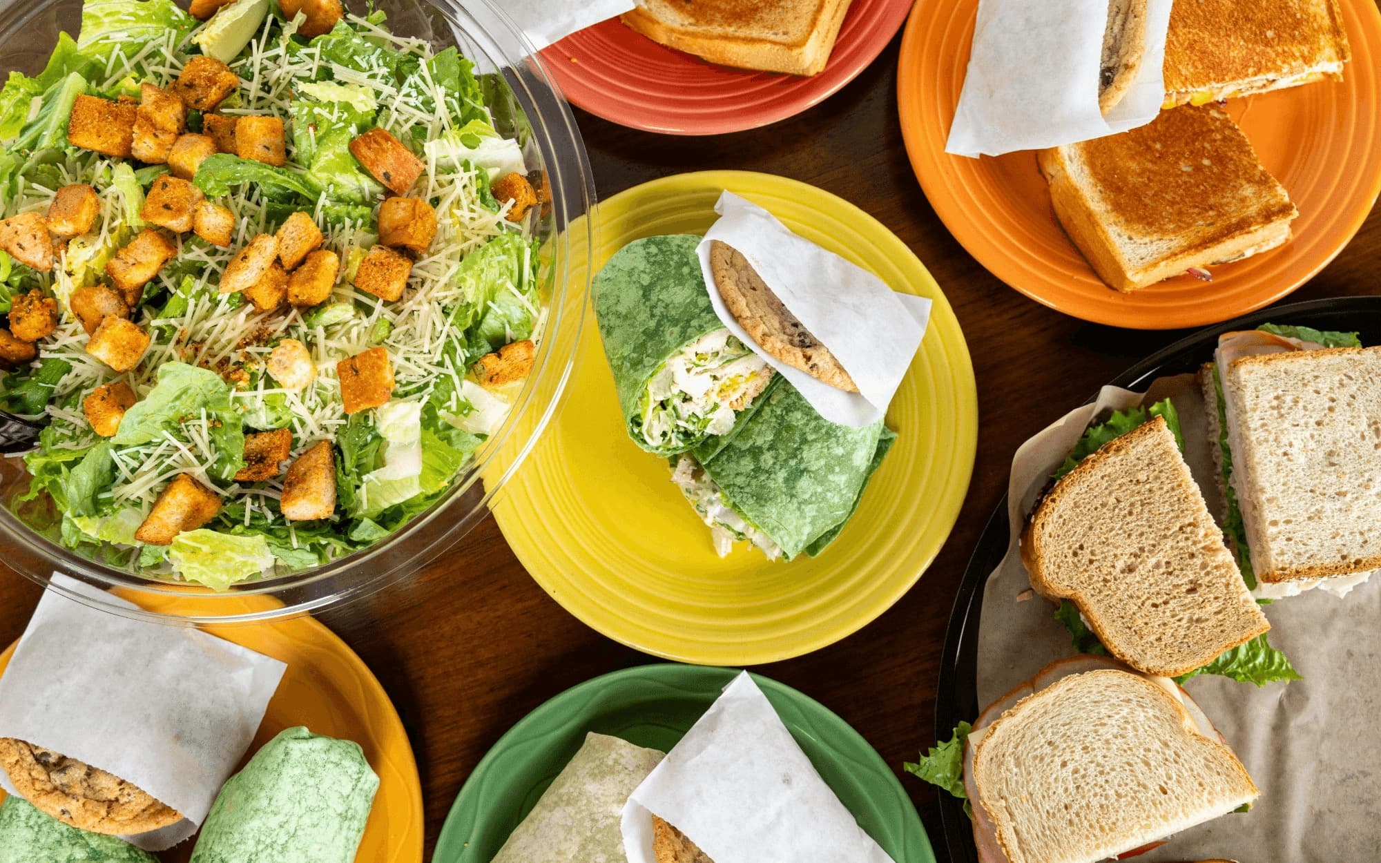 Paradise Bakery & Café spread with salads, wraps, cookies, and sandwiches